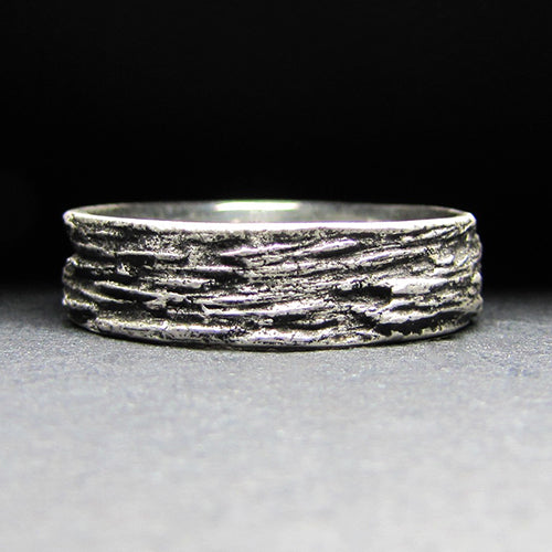 14kw wedding band, delicately textured with intricate patterns of tree bark, symbolizing strength, growth, and the enduring bond shared between two souls.