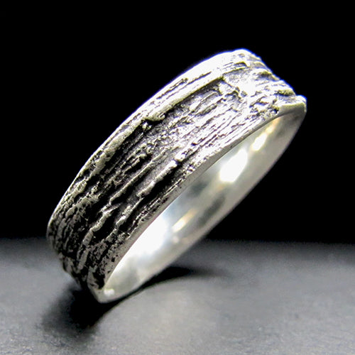 14kw wedding band, delicately textured with intricate patterns of tree bark, symbolizing strength, growth, and the enduring bond shared between two souls.