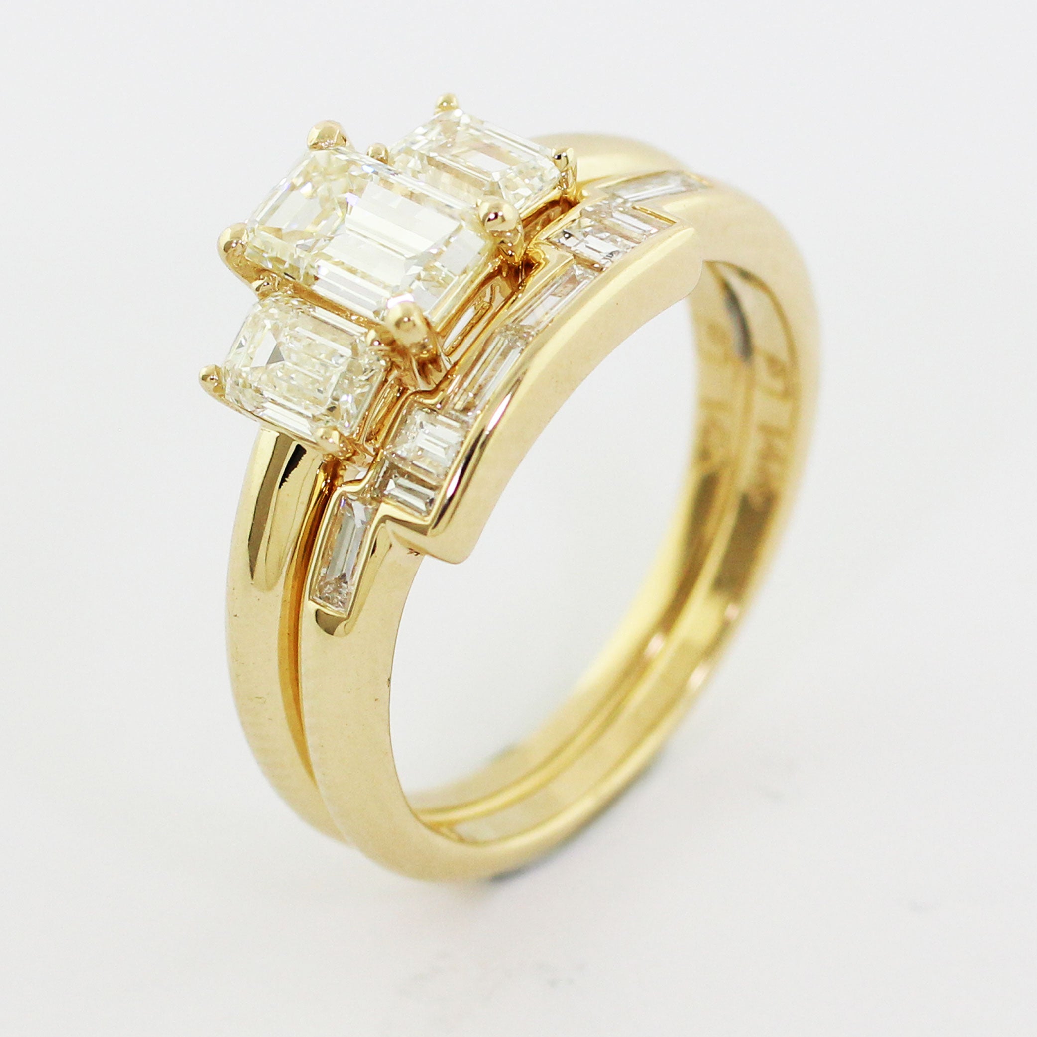 A custom 14k yellow gold form-fitting shadow band featuring a blend of heirloom and new diamond baguettes, channel set for captivating sparkle.