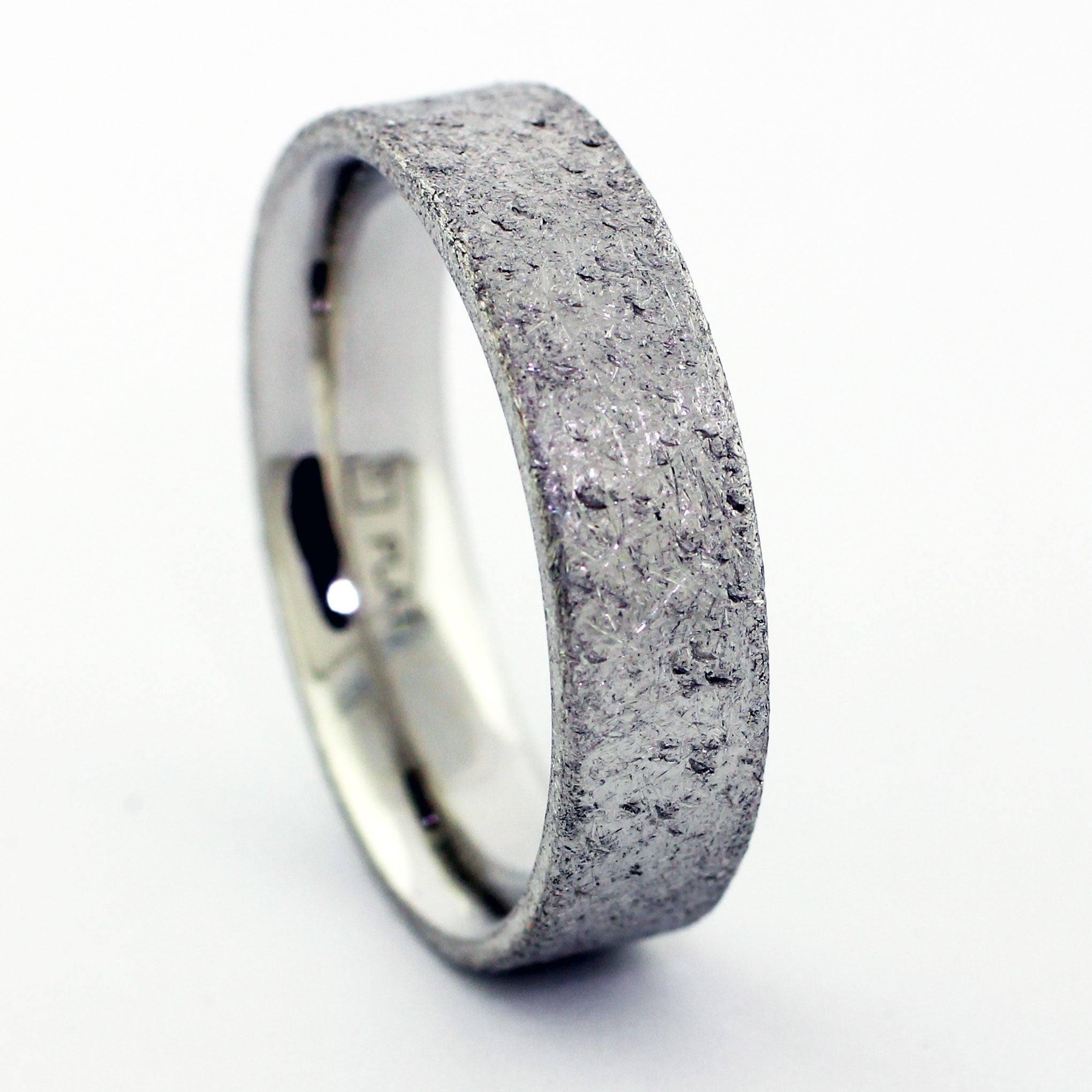 Rough, rustic, and distressed. A new scratch or scuff will only add to it's beauty. A timeless wedding band that can be dressed up or stripped down to meet the needs of the wearer. -Made to order and hand fabricated from palladium-