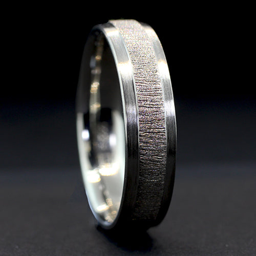 Fabricated from palladium the focal point of this ring is the bright diamond cut raised center, framed on both sides by dropped outer edges. This design creates a striking contrast, accentuating the raised center and adding depth to the band.