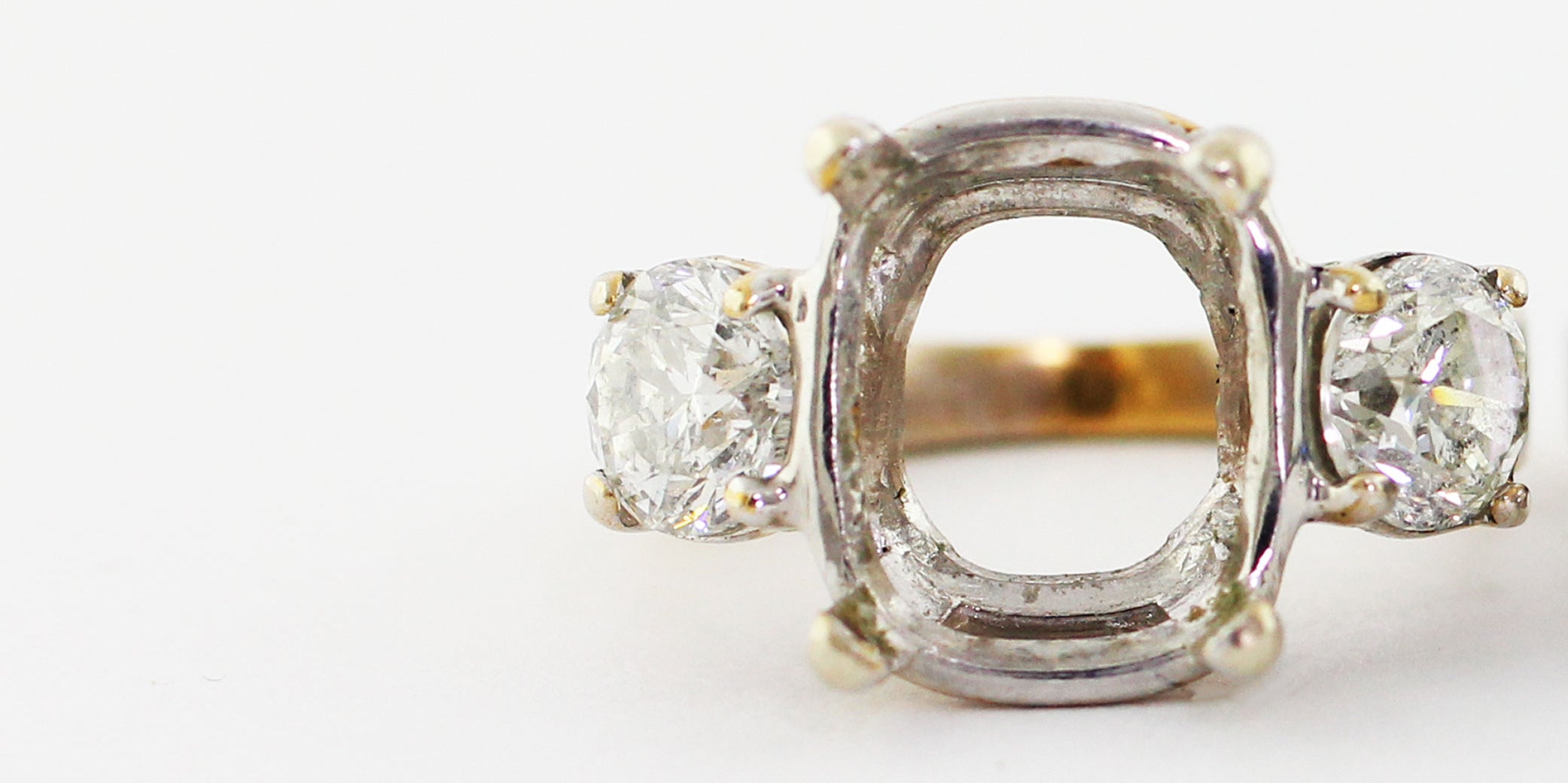 14k white gold three stone ring in need of a replacement center stone.