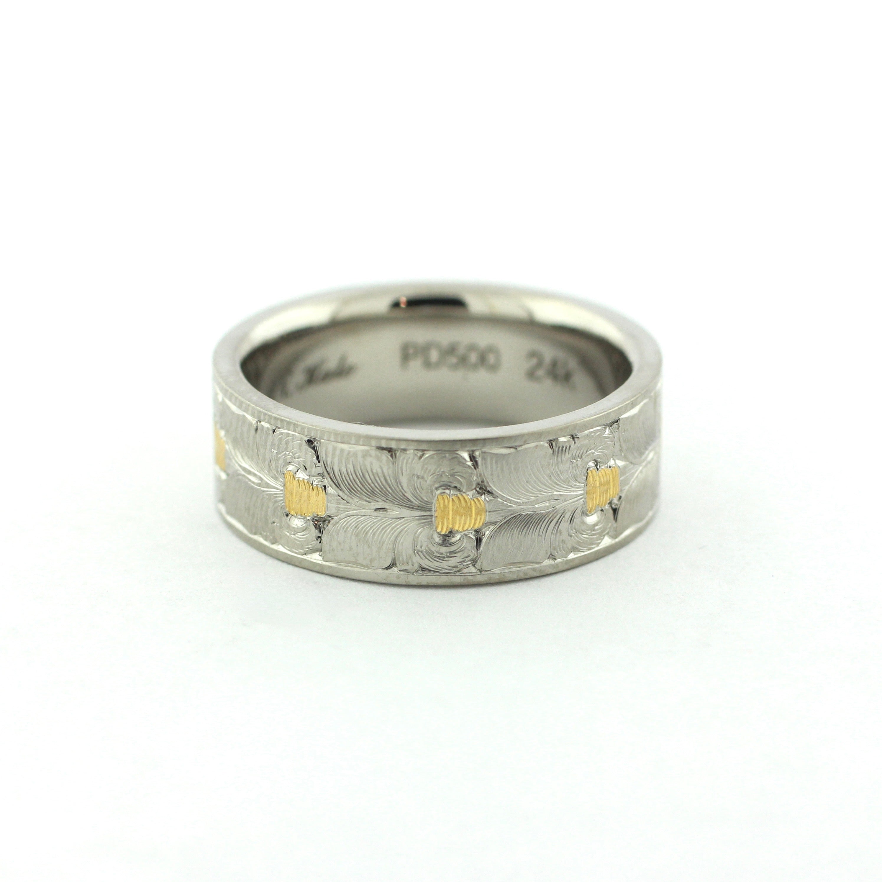 The Colt hand-engraved PD500 palladium band with wheat leaf-inspired engraving and gold inlay accents.