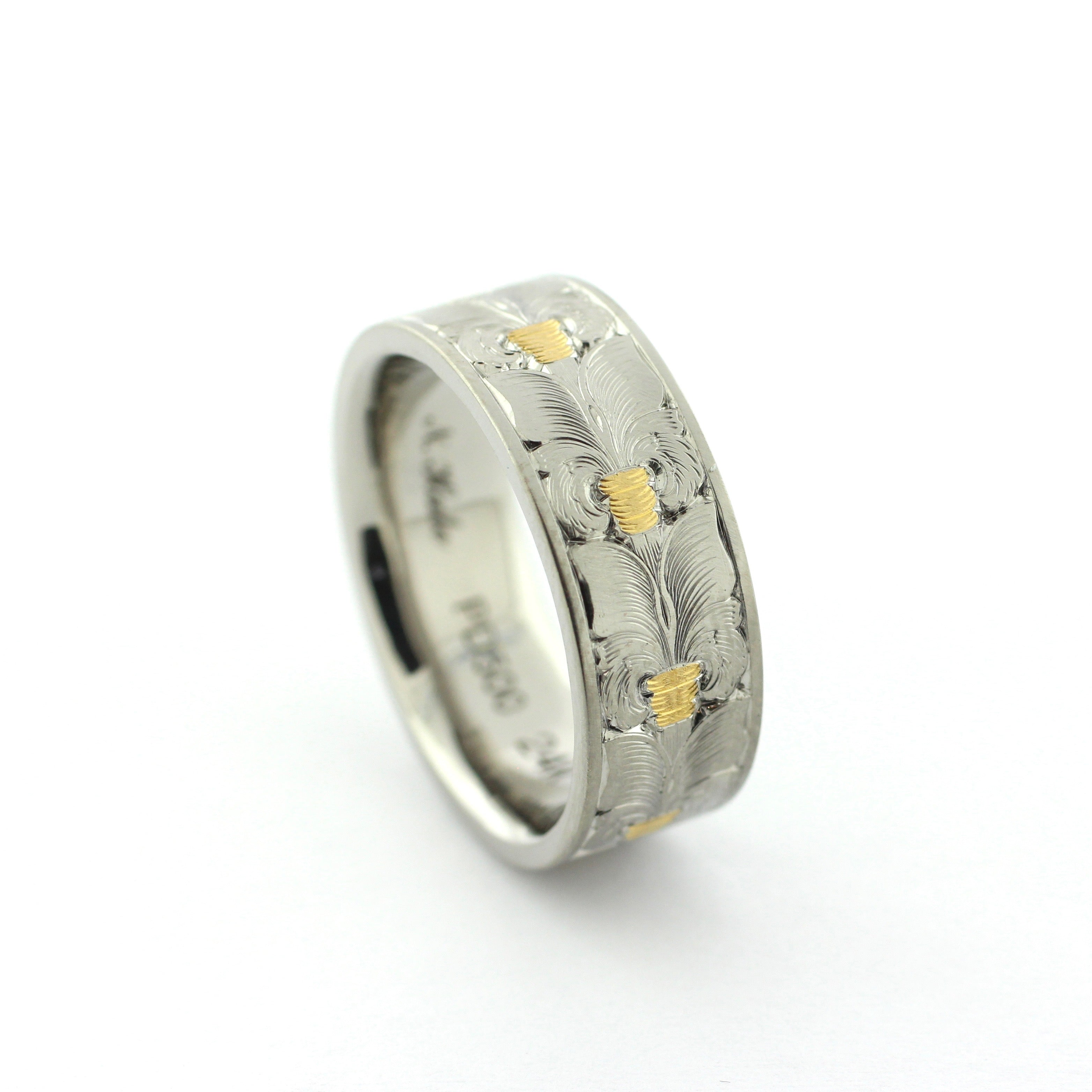 The Colt hand-engraved PD500 palladium band with wheat leaf-inspired engraving and gold inlay accents.
