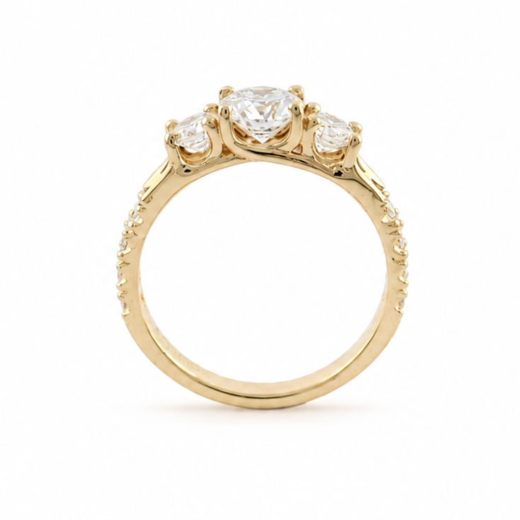 Smith three-stone diamond ring in 14k yellow gold with fishtail-set diamond melee along the side shanks.