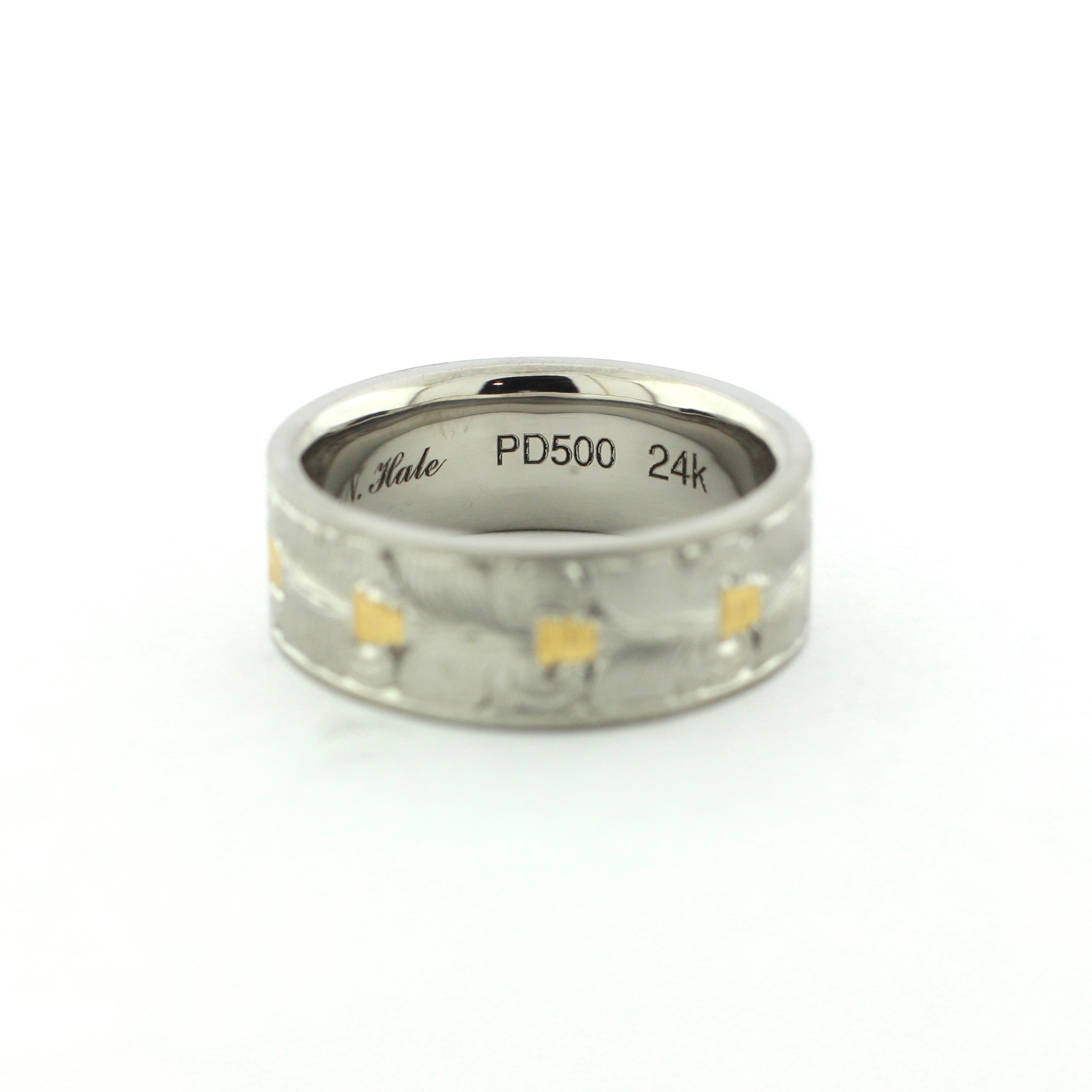 The Colt hand-engraved PD500 palladium band with wheat leaf-inspired engraving and gold inlay accents.