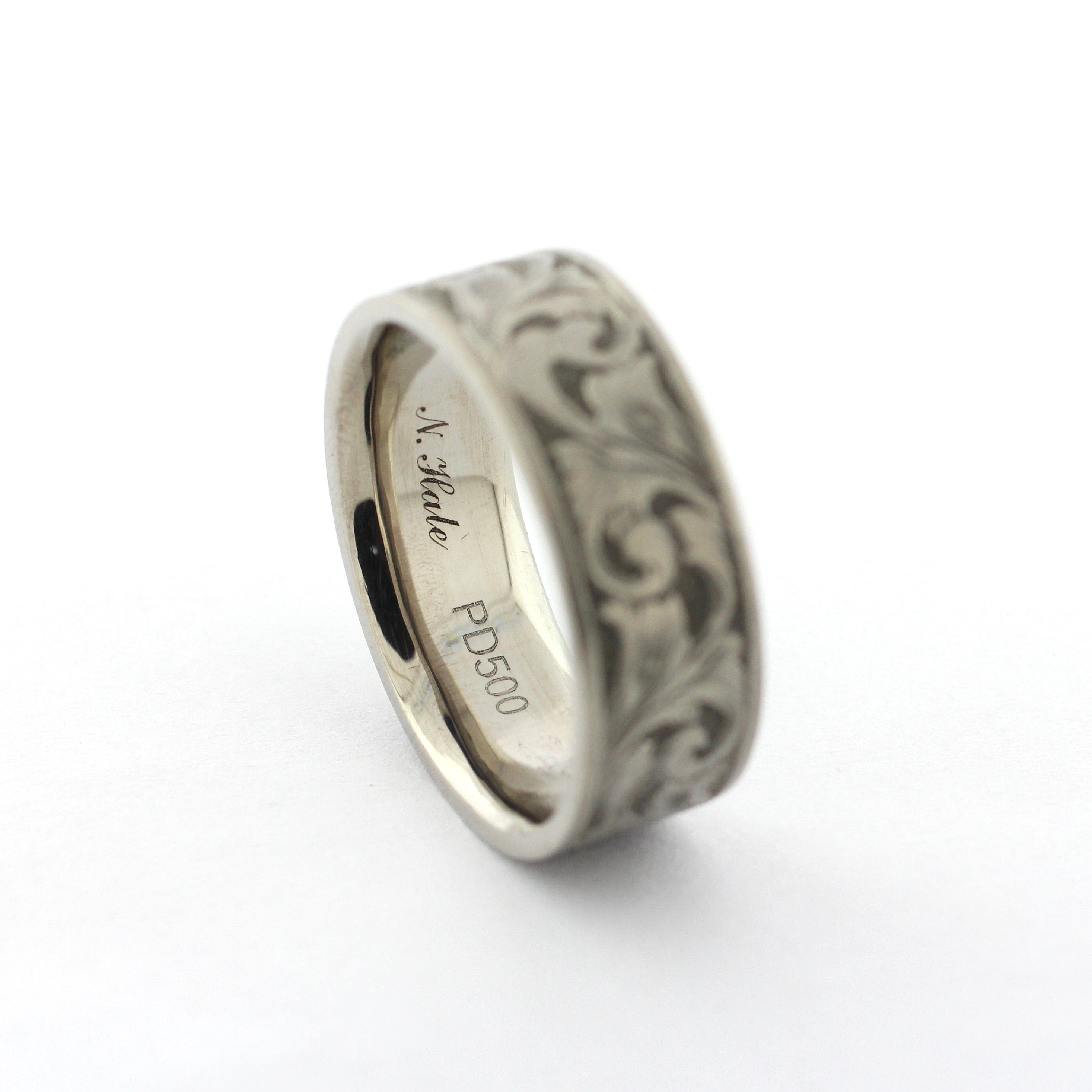 The Remington hand-engraved PD500 palladium band with flowing scrollwork inspired by classic American engraving.