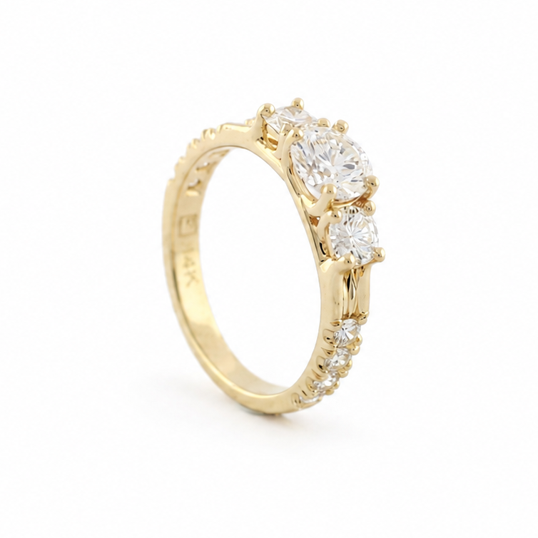 Smith three-stone diamond ring in 14k yellow gold with fishtail-set diamond melee along the side shanks.