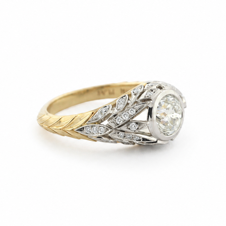 Van Zyl two-tone platinum and 14k yellow gold ring with a 1 ct old mine cut diamond, diamond accents, and hand-sculpted laurel leaf shank