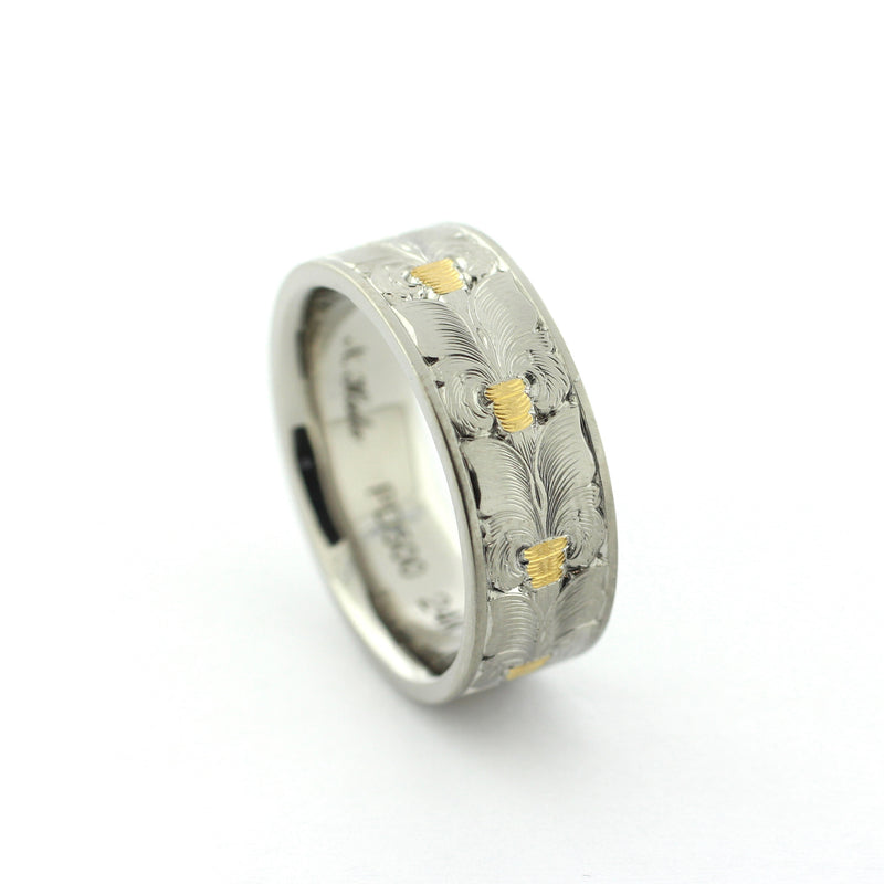 The Colt hand-engraved PD500 palladium band with wheat leaf-inspired engraving and gold inlay accents.